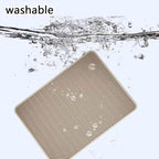 Washable pet mat with textured surface submerged in water for easy cleaning