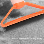 Orange pet hair remover with metal serrated shaving head on gray fabric