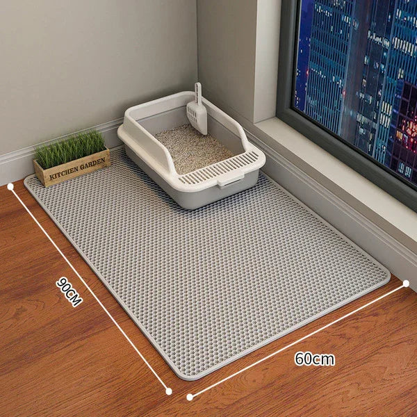 Gray cat litter mat with 90x60cm dimensions, placed under litter box near window, ideal for pet mess control.